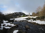 SX02580 Glendasan river in front of Round Tower Glendalough in snow.jpg